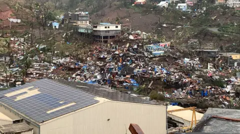 Getty Images Metal sheets, wood, furniture and belongings after the cyclone Chido hit France's Indian Ocean territory of Mayotte, 15 December 2024.