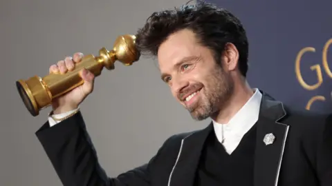 Getty Images Sebastian Stan, winner of Best Performance by a Male Actor in a Motion Picture – Musical or Comedy Award for “A Different Man” poses in the press room during the 82nd Annual Golden Globe Awards at The Beverly Hilton on January 05, 2025 in Beverly Hills, California