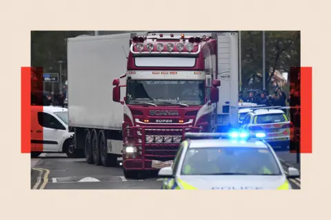 Getty Images Police officers drive escort the lorry in which 39 dead bodies were discovered