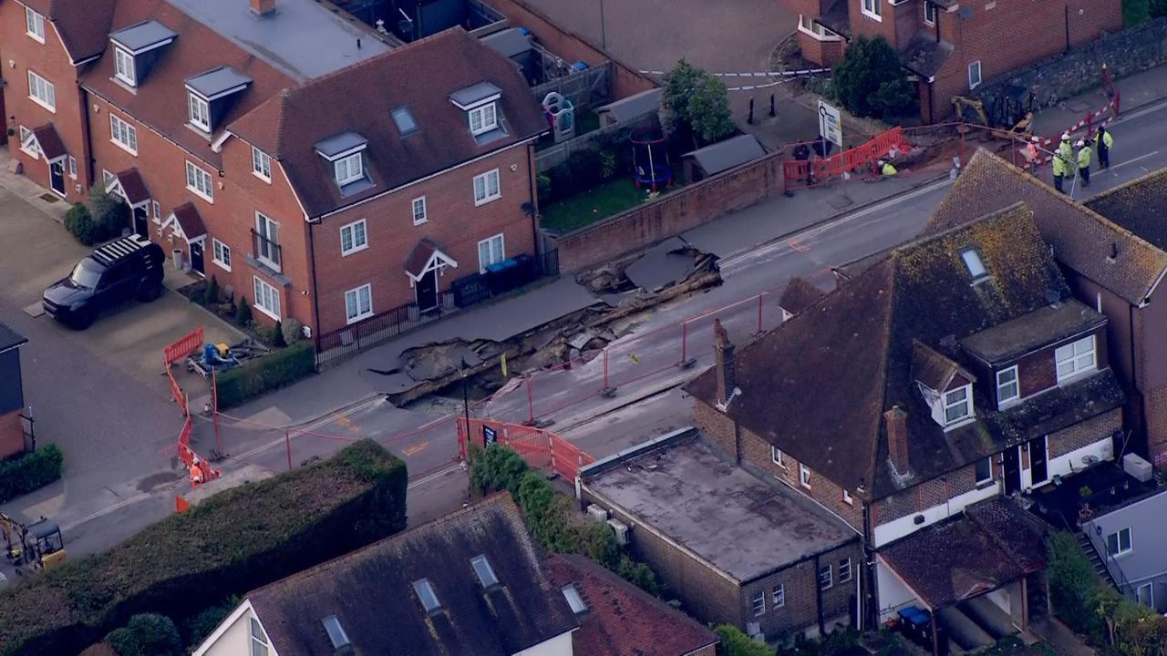 Large sinkhole forces closure of Godstone High Street in Surrey following burst water pipe